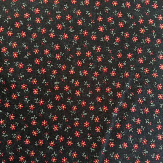 Small floral quilting cotton fabric from the Daisy Lane collection by Kansas Troubles Quilters for Moda Fabrics featuring scattered blossoms in Carnation and Mulch colorways.