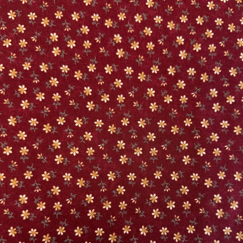 Small floral quilting cotton fabric from the Daisy Lane collection by Kansas Troubles Quilters for Moda Fabrics featuring scattered blossoms in Carnation and Mulch colorways.