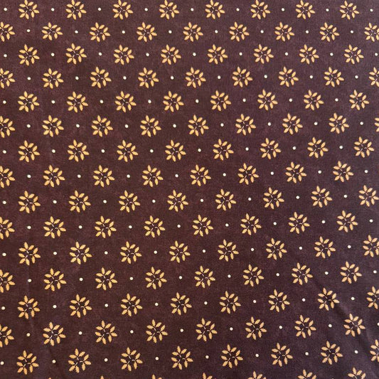Wheatland quilting cotton fabric by Kansas Troubles Quilters for Moda Fabrics featuring a small repeating floral motif in warm beige tones on a rich mulberry background.