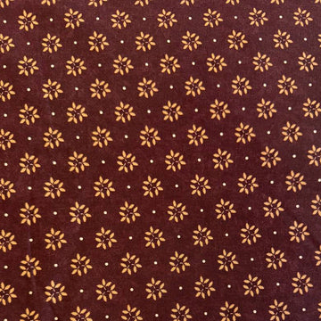 Wheatland quilting cotton fabric by Kansas Troubles Quilters for Moda Fabrics featuring a small repeating floral motif in warm beige tones on a rich mulberry background.