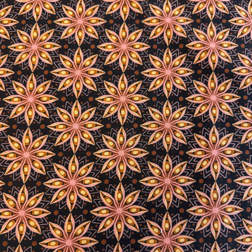 Acorn Hollow quilting cotton fabric by BasicGrey for Moda Fabrics featuring repeating geometric starburst motifs in pink, gold, and amber tones on a deep soil brown background.