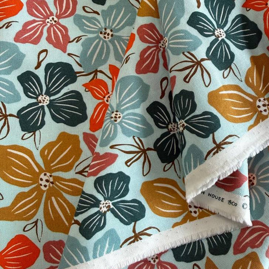 Large floral quilting cotton fabric from the Things Above collection by Fancy That Design House for Moda Fabrics featuring colorful hand-drawn flowers on Eggshell, Cocoa, and Water backgrounds.