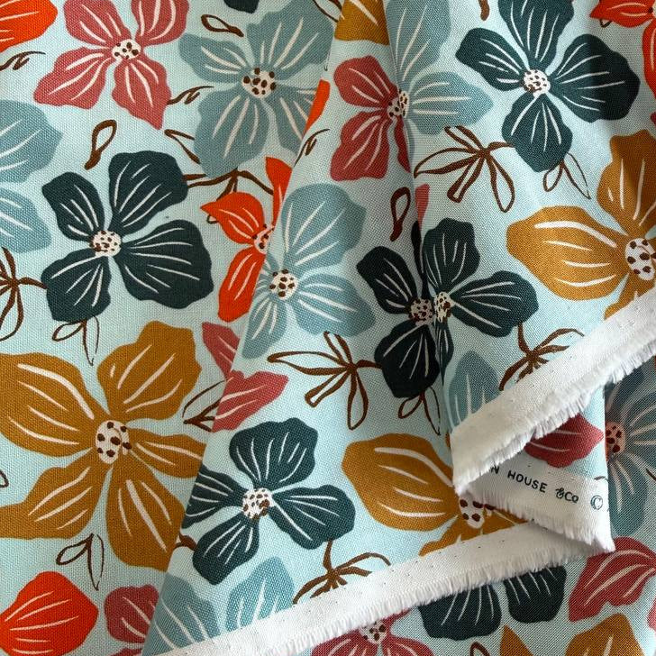 Large floral quilting cotton fabric from the Things Above collection by Fancy That Design House for Moda Fabrics featuring colorful hand-drawn flowers on Eggshell, Cocoa, and Water backgrounds.