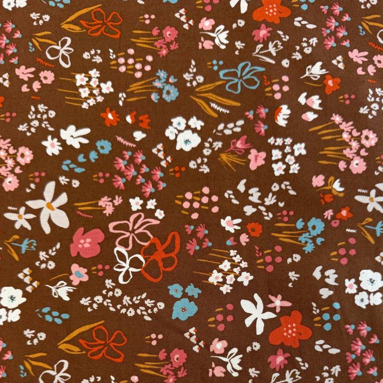 Small scattered wildflowers and botanical motifs on quilting cotton fabric, available in Deep Sea teal and Cocoa brown colourways from Moda's Things Above collection.