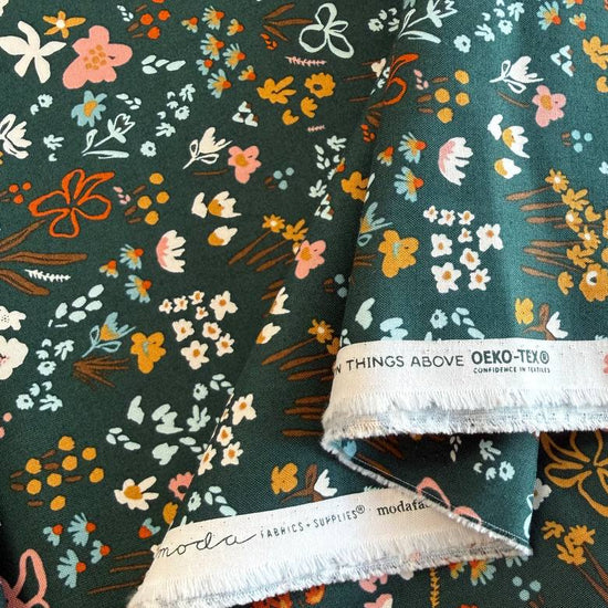 Small scattered wildflowers and botanical motifs on quilting cotton fabric, available in Deep Sea teal and Cocoa brown colourways from Moda's Things Above collection.