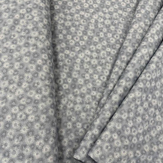100% cotton tonal sunburst print fabric available in blue, sage green, charcoal grey and cream, 60 inches wide.