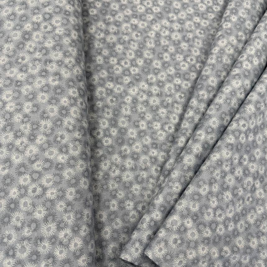 100% cotton tonal sunburst print fabric available in blue, sage green, charcoal grey and cream, 60 inches wide.