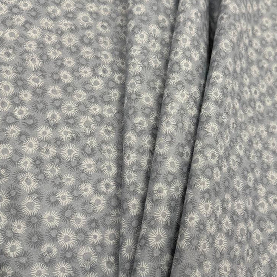 100% cotton tonal sunburst print fabric available in blue, sage green, charcoal grey and cream, 60 inches wide.