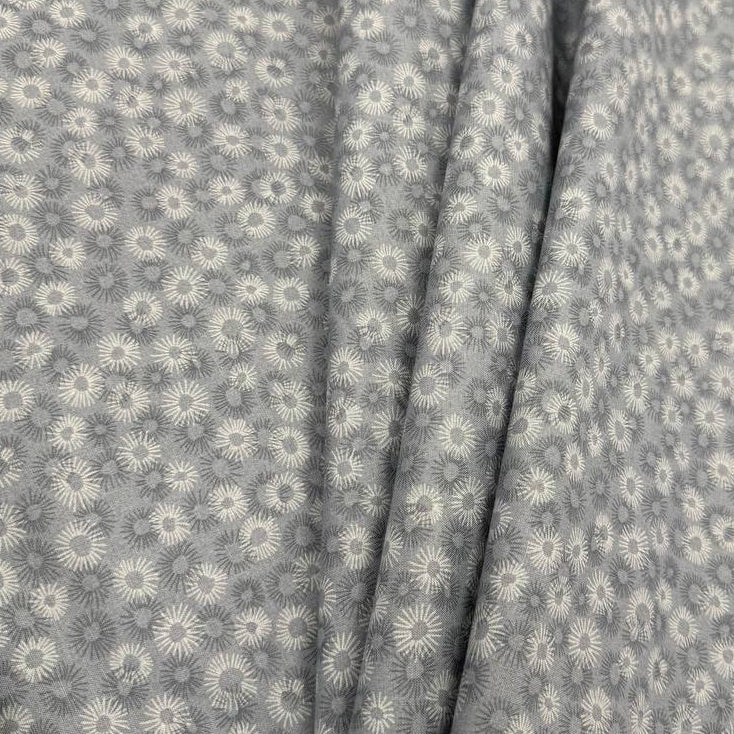 100% cotton tonal sunburst print fabric available in blue, sage green, charcoal grey and cream, 60 inches wide.