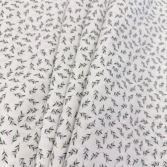 Ecru 100% cotton poplin fabric with delicate small green leaf print, 150 cm wide – Sasha’s Atelier.