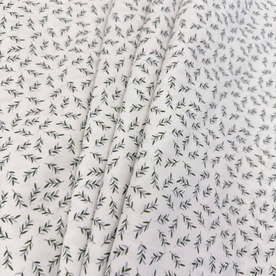 Ecru 100% cotton poplin fabric with delicate small green leaf print, 150 cm wide – Sasha’s Atelier.