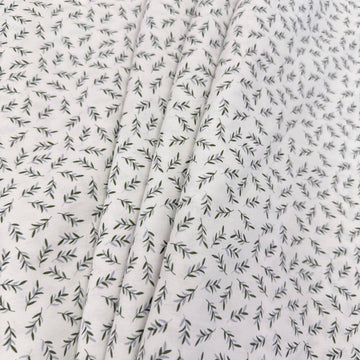 Ecru 100% cotton poplin fabric with delicate small green leaf print, 150 cm wide – Sasha’s Atelier.