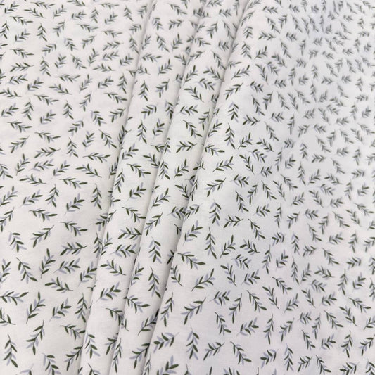 Ecru 100% cotton poplin fabric with delicate small green leaf print, 150 cm wide – Sasha’s Atelier.