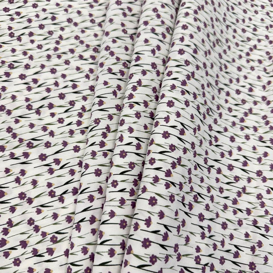 White 100% cotton poplin fabric with delicate purple cyclam flower print, 150 cm wide – Sasha’s Atelier.