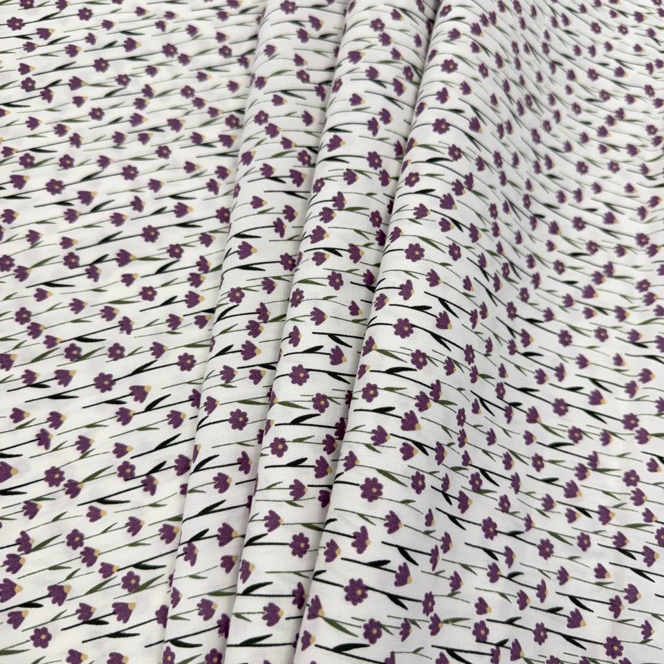 White 100% cotton poplin fabric with delicate purple cyclam flower print, 150 cm wide – Sasha’s Atelier.