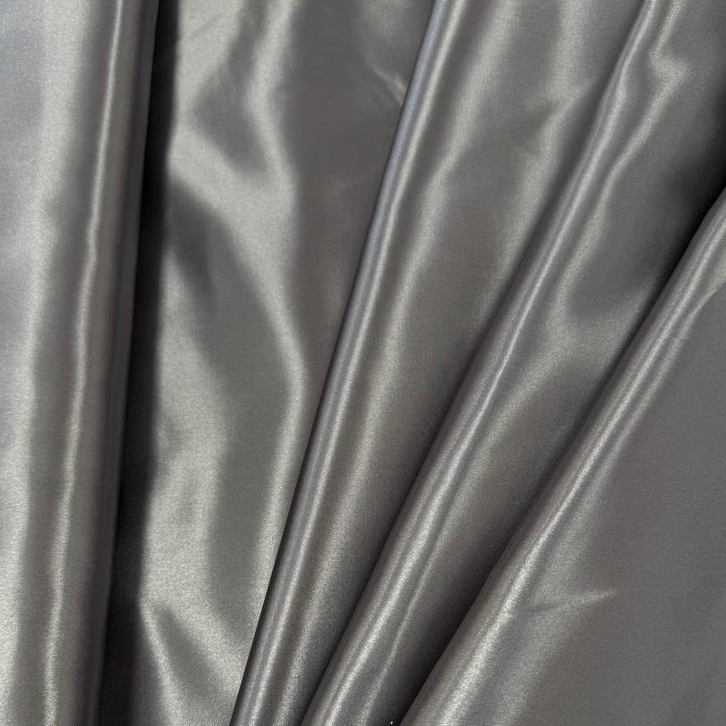 Alt text:
Satin De Luxe polyester fabric available in multiple colours including black, brown, off white, bottle green, poudre pink, antracite grey, optical white, red and navy.