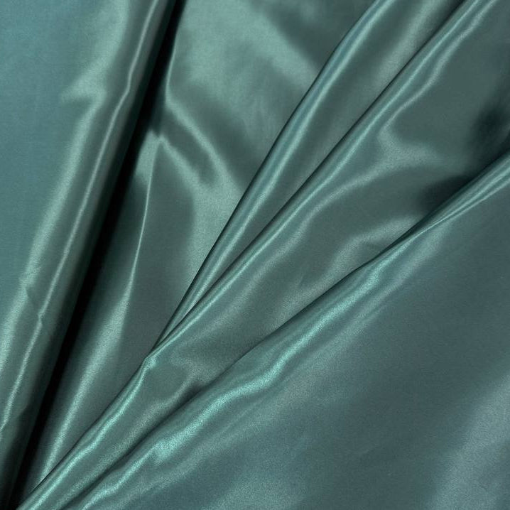Alt text:
Satin De Luxe polyester fabric available in multiple colours including black, brown, off white, bottle green, poudre pink, antracite grey, optical white, red and navy.