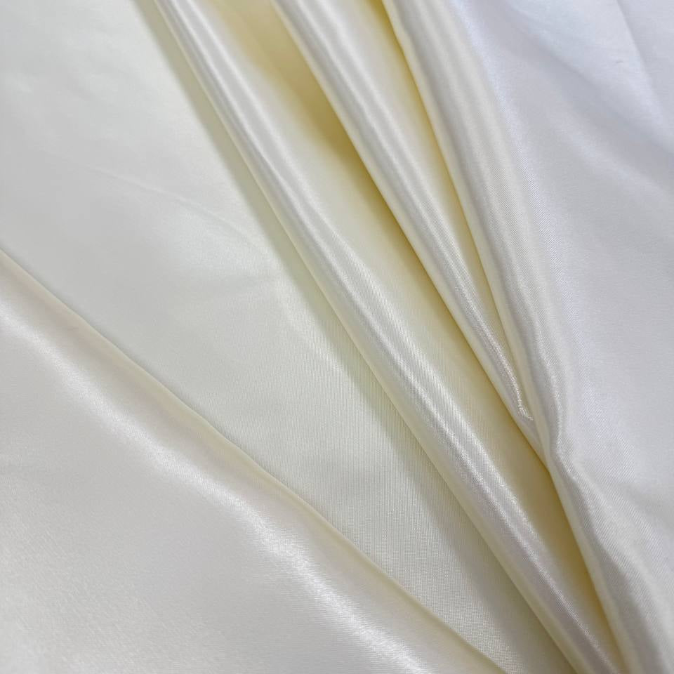 Alt text:
Satin De Luxe polyester fabric available in multiple colours including black, brown, off white, bottle green, poudre pink, antracite grey, optical white, red and navy.