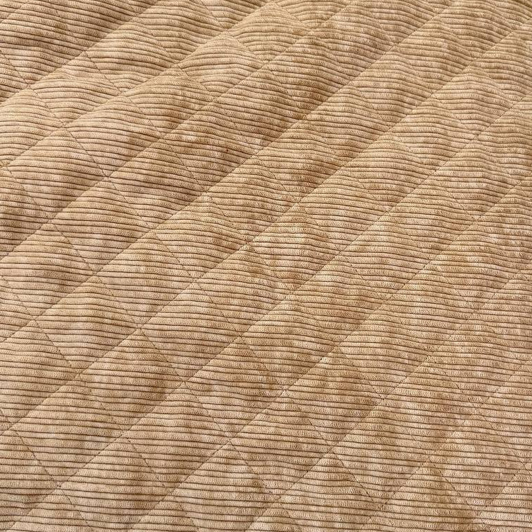 Quilted ribbed corduroy fabric with soft plush backing available in Champagne, Brown, Khaki, Taupe and Sand