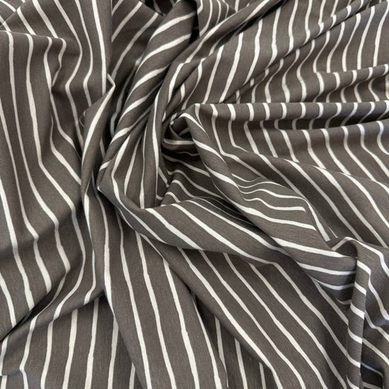 Taupe cotton jersey knit fabric with light vertical stripes, 95% cotton and 5% elastane, 200 GSM.