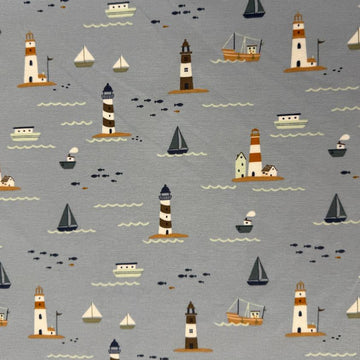 Dusty blue cotton jersey knit fabric with nautical boats, lighthouses and seaside print