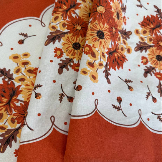 Classic Retro 100% cotton toweling with rust orange and golden floral bouquets, cream centre and rust border.
