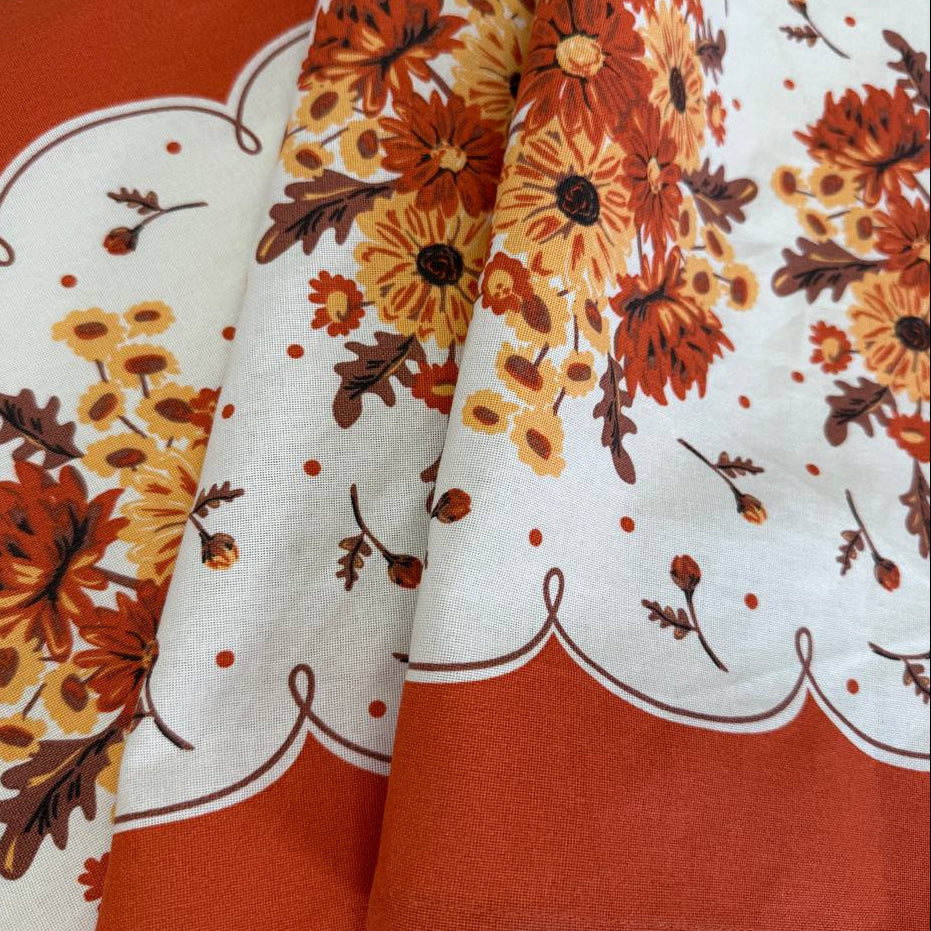 Classic Retro 100% cotton toweling with rust orange and golden floral bouquets, cream centre and rust border.