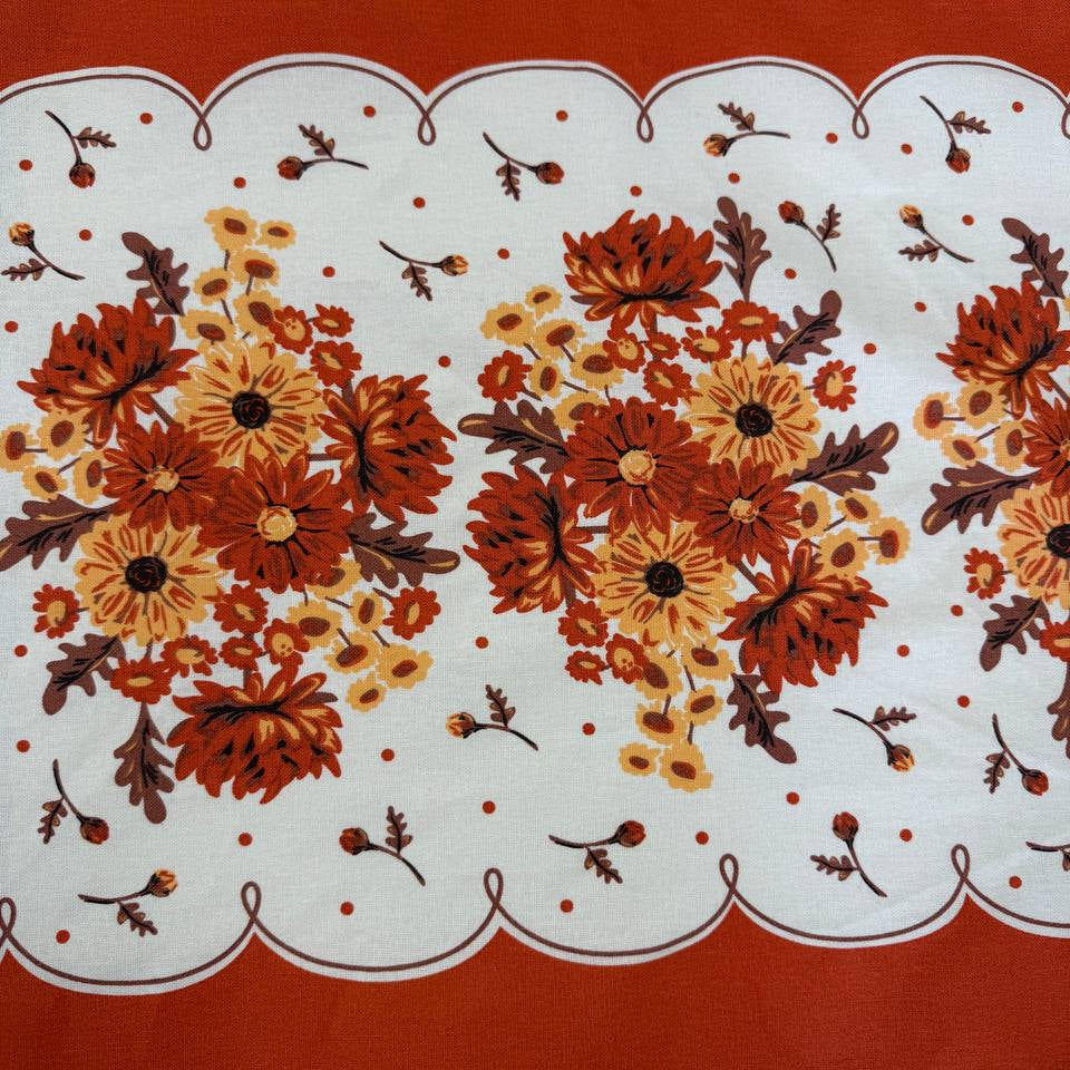 Classic Retro 100% cotton toweling with rust orange and golden floral bouquets, cream centre and rust border.