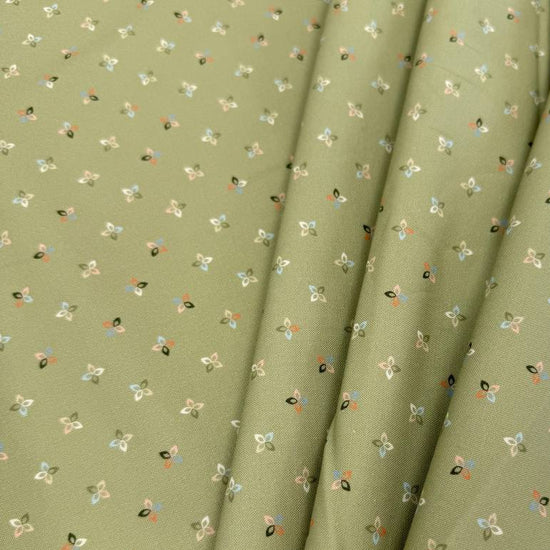 Petalush Meadow sage green cotton fabric by Kiley's Quilt Room for Moda Fabrics, featuring tiny white, peach and blue floral motifs.
