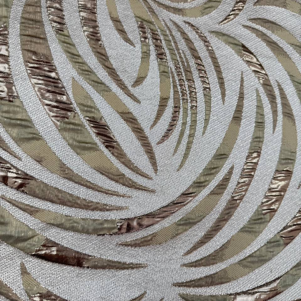 Shiny jacquard fabric in sand, champagne and gold tones featuring a textured abstract leaf pattern with metallic accents.