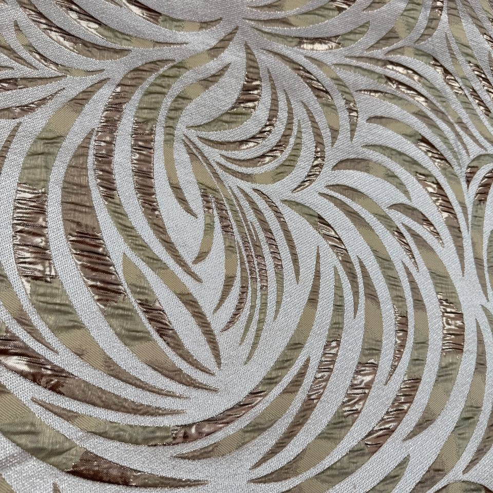 Shiny jacquard fabric in sand, champagne and gold tones featuring a textured abstract leaf pattern with metallic accents.