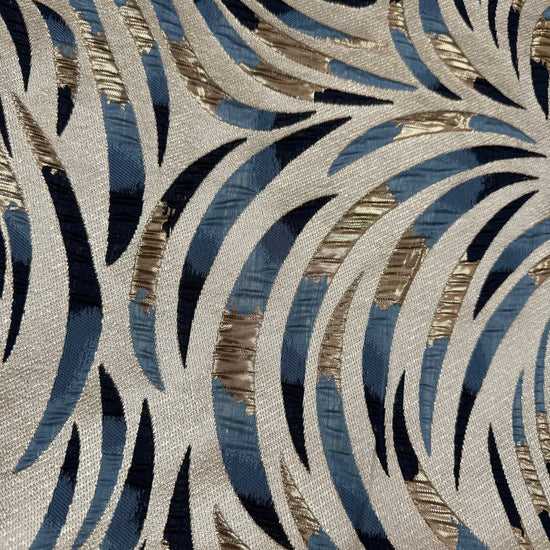 Shiny jacquard fabric in denim blue, navy and gold featuring a raised abstract leaf pattern with shimmering metallic details.