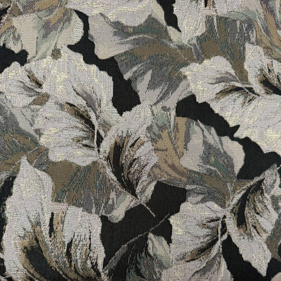 Beige fancy jacquard fabric featuring an elegant woven leaf pattern in grey, taupe and black with subtle metallic accents.
