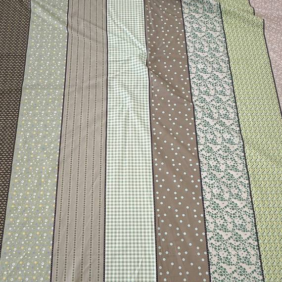 Moda Gathered Lollies Trentham One cotton fabric featuring vertical stripes with floral, gingham and dotted patterns in sage green, olive, beige and cream.