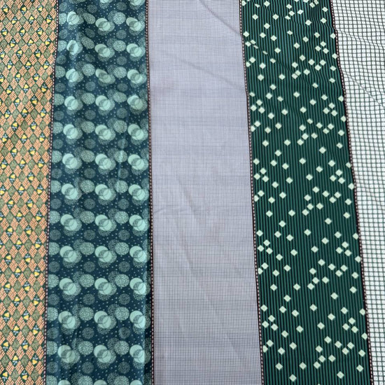 Gathered Lollies Moda cotton fabric featuring vertical patchwork-inspired stripes with floral, gingham and geometric patterns in teal, sage green, mint, blue and beige.