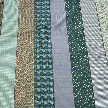 Gathered Lollies Moda cotton fabric featuring vertical patchwork-inspired stripes with floral, gingham and geometric patterns in teal, sage green, mint, blue and beige.