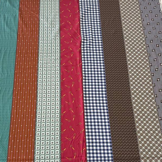 Gathered Lollies cotton fabric by Jen Kingwell for Moda featuring colourful vertical stripes with gingham, floral and geometric patterns in teal, rust, red, navy, brown and cream.