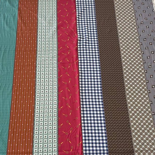 Gathered Lollies cotton fabric by Jen Kingwell for Moda featuring colourful vertical stripes with gingham, floral and geometric patterns in teal, rust, red, navy, brown and cream.