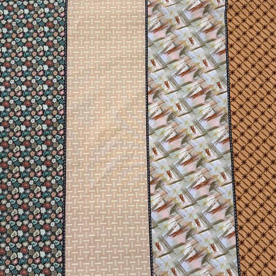 Gathered Lollies cotton fabric by Jen Kingwell for Moda featuring vertical patchwork-inspired stripes with floral and geometric prints in peach, terracotta, burgundy, cream and teal.