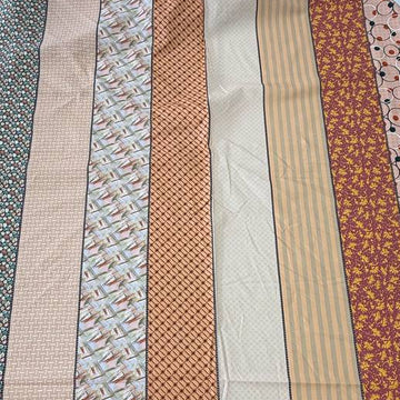 Gathered Lollies cotton fabric by Jen Kingwell for Moda featuring vertical patchwork-inspired stripes with floral and geometric prints in peach, terracotta, burgundy, cream and teal.