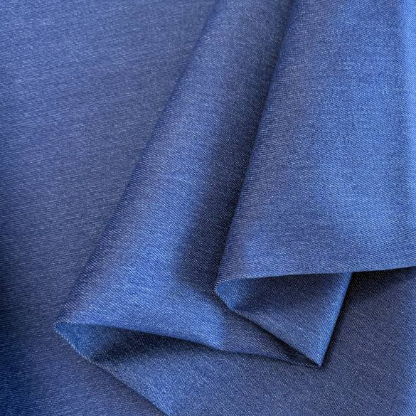 Classic Stretch Denim fabric available in two colors: True Blue and Medium Blue. Medium-weight stretch denim made from 70% cotton, 28% polyester, and 2% spandex, ideal for jeans, jackets, skirts, and dresses.