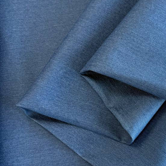 Classic Stretch Denim fabric available in two colors: True Blue and Medium Blue. Medium-weight stretch denim made from 70% cotton, 28% polyester, and 2% spandex, ideal for jeans, jackets, skirts, and dresses.
