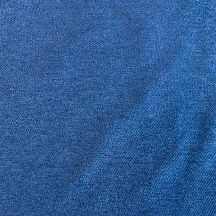 Classic Stretch Denim fabric available in two colors: True Blue and Medium Blue. Medium-weight stretch denim made from 70% cotton, 28% polyester, and 2% spandex, ideal for jeans, jackets, skirts, and dresses.