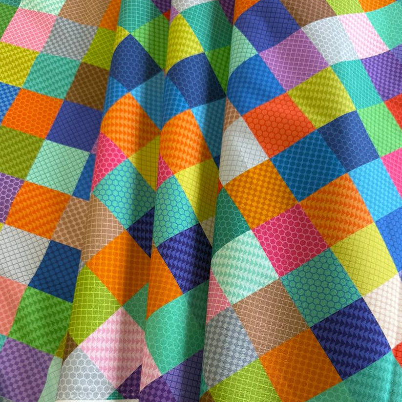 Colorful patchwork geometric quilting cotton fabric from the Animal Alphabet collection by Lewis & Irene, featuring multicolored square blocks on 100% cotton.