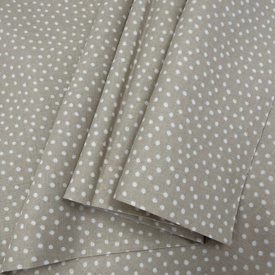 Story Book Dots quilting cotton fabric in taupe with delicate white dotted pattern, 100% cotton, 45 inch wide.