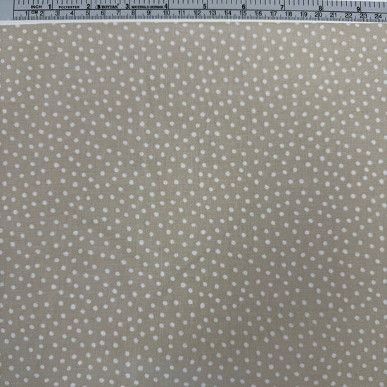 Story Book Dots quilting cotton fabric in taupe with delicate white dotted pattern, 100% cotton, 45 inch wide.
