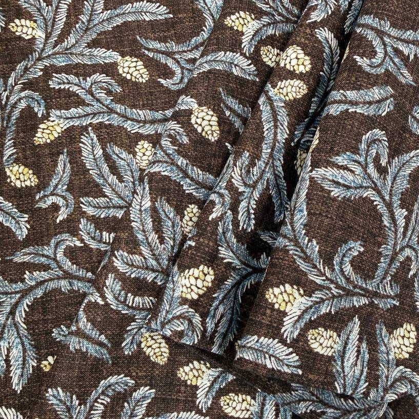 Brown quilting cotton fabric with blue leafy floral vines and cream pinecone print, 100% cotton, 45 inch wide