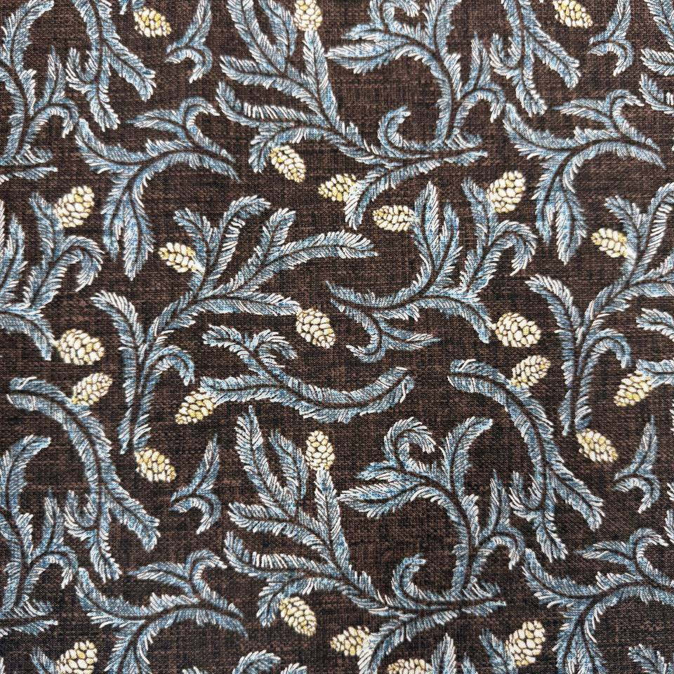Brown quilting cotton fabric with blue leafy floral vines and cream pinecone print, 100% cotton, 45 inch wide