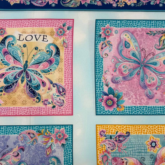 Faith & Grace Boxes Multi cotton fabric panel by Kanvas Studio for Benartex featuring six colorful butterfly blocks with floral and paisley designs on a light aqua background.
