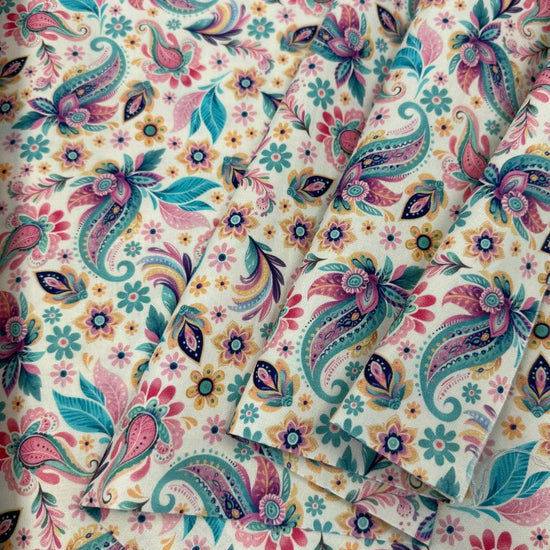 Faith & Grace cotton fabric by Kanvas Studio for Benartex featuring colorful butterflies, paisley motifs, and floral accents on a soft white background.